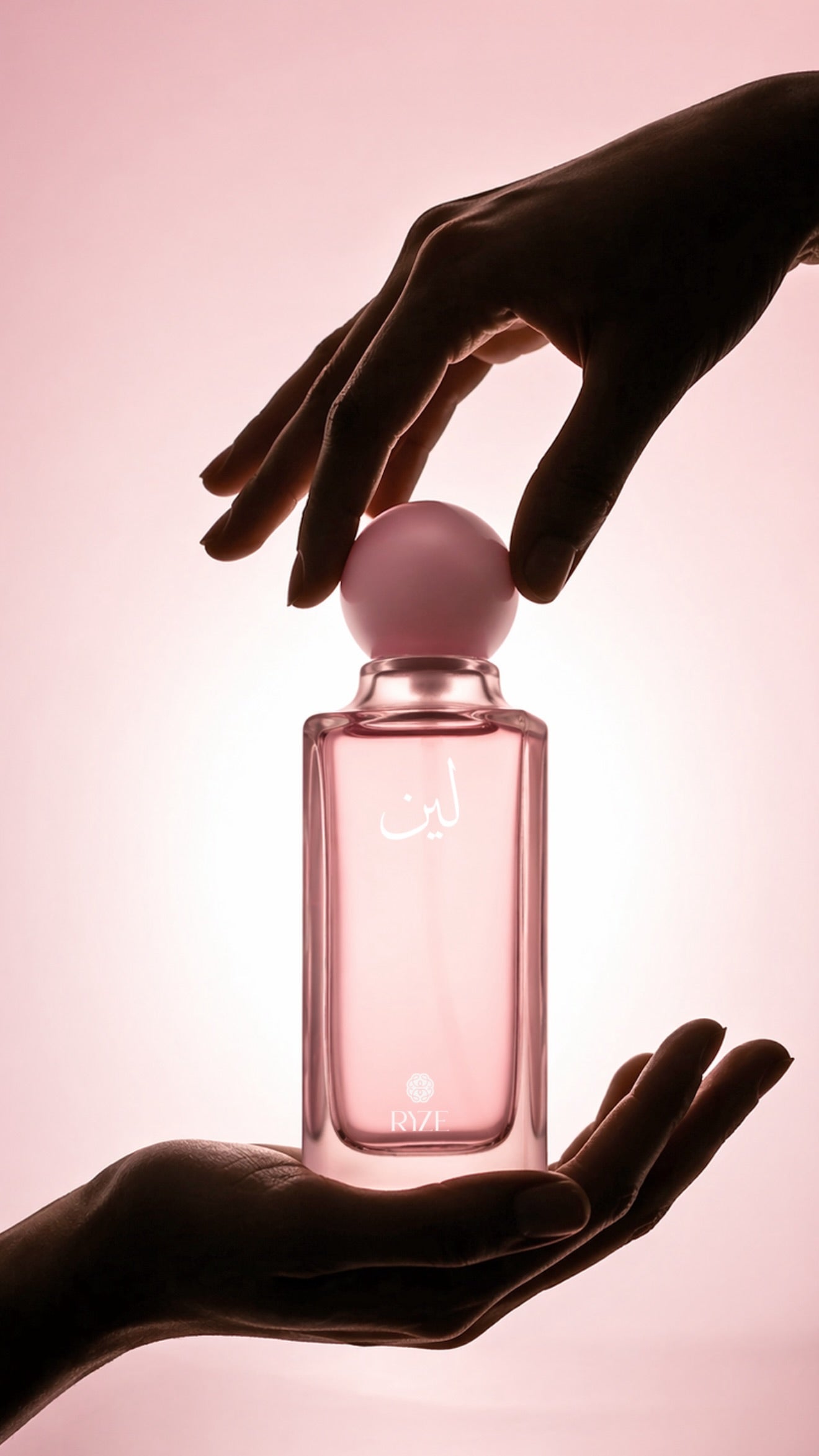 Hands presenting the Leen fragrance bottle